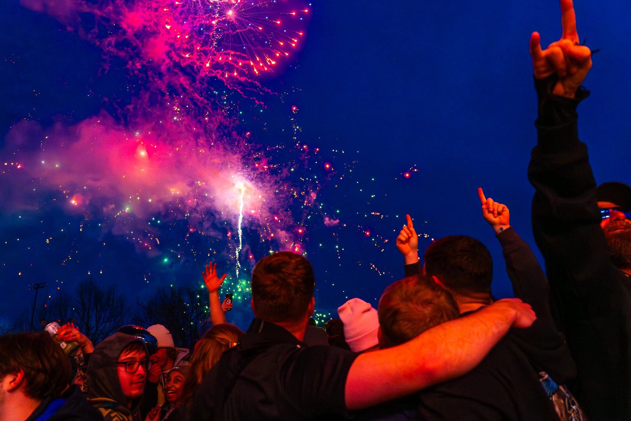 Mountainfest guests watching colorful fireworks light up the night